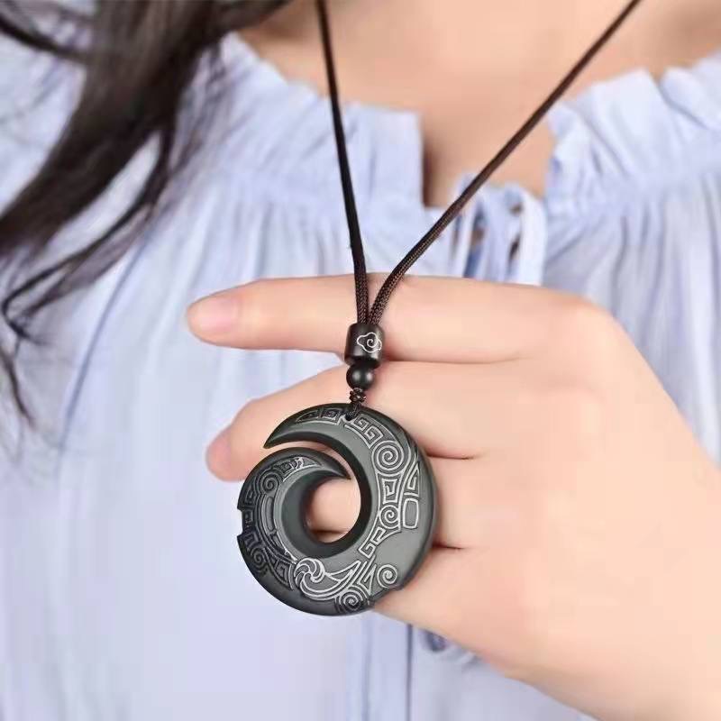 Obsidian transport pendant with Chinese elements paired with unisex design