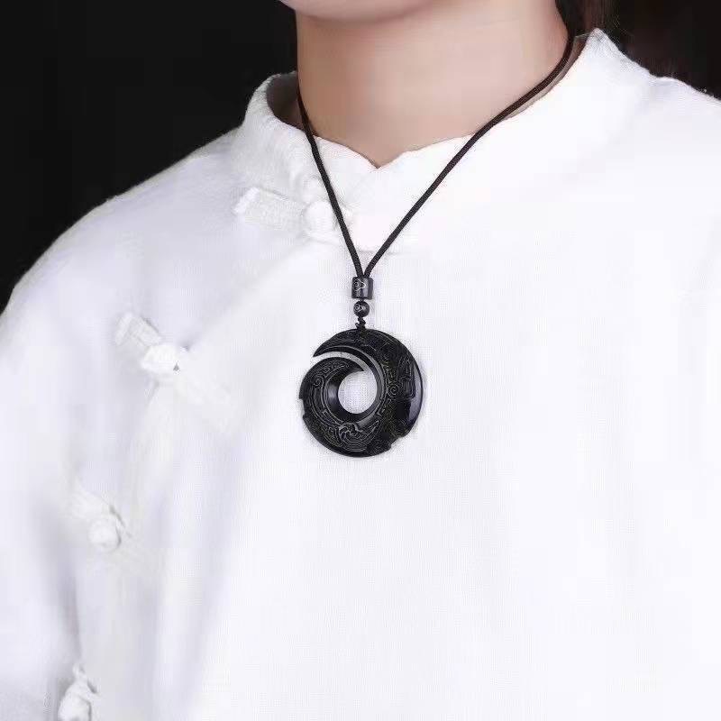 Obsidian transport pendant with Chinese elements paired with unisex design