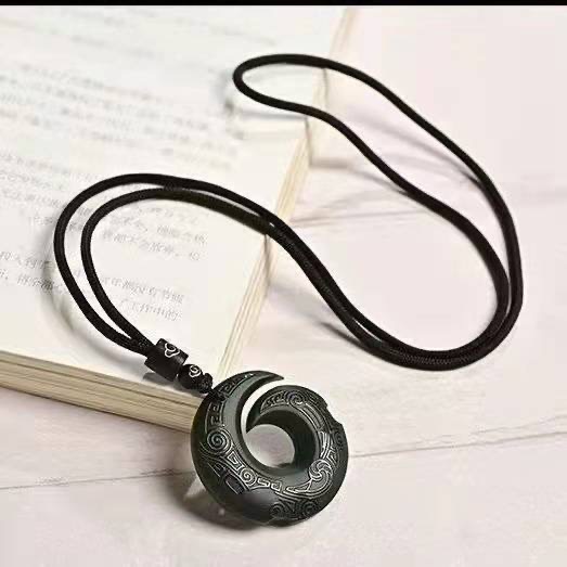 Obsidian transport pendant with Chinese elements paired with unisex design